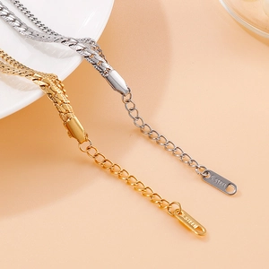 Double-layered gold and silver stainless steel shell bracelets on white porcelain