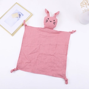 Detailed view of pink cotton muslin baby security blanket with cute bunny head and knots