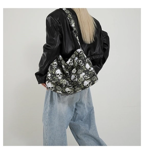 Detail of nylon tote bag featuring skull and rose prints with adjustable wide shoulder strap