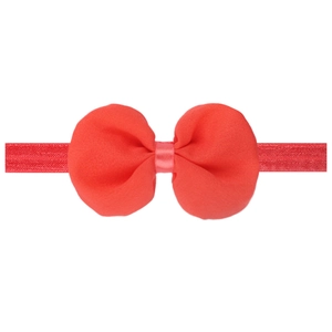 Detail of red chiffon bow baby headband showing the soft texture and elastic band