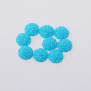 Detailed view of 12mm round blue resin druzy cabochons with sparkling crystal texture