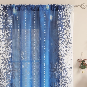 Detail of blue snowflake curtains showing the delicate sheer fabric and star patterns