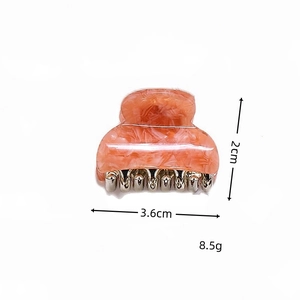Mini acetate hair claw clip with orange marble pattern showing 3.6cm size measurements