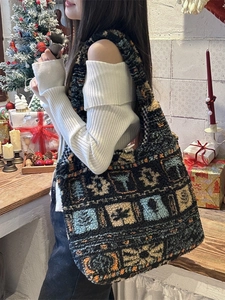 Ethnic style plush tote bag with geometric patterns in a cozy Christmas setting