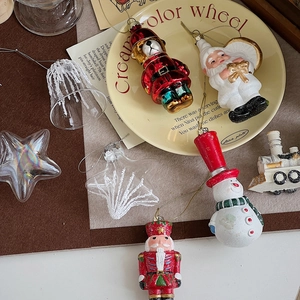 Festive Christmas ornaments featuring Santa, nutcracker, and bear on vintage paper