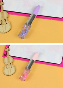 Detail of creative lipstick-shaped pens with colorful floating glitter liquid inside