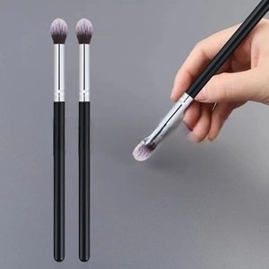 Detailed view of three black makeup blending brushes with gradient soft synthetic bristles