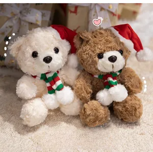 Detail of plush teddy bears wearing festive Christmas hats and scarves on soft rug
