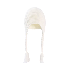 Close-up of white knit baby hat showing textured braid details and soft tassel finish