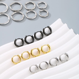 Detail of 18K gold and silver stainless steel hoop earrings in various sizes and finishes