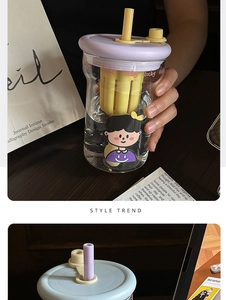 Detail of high borosilicate glass cup with tea filter, purple lid and cartoon stickers