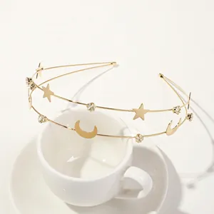 Detail of gold moon and star headband with sparkling rhinestones for bridal hair