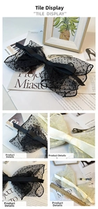 Detail shot of a 20cm oversized polka dot mesh bow hair clip with double-layer lace
