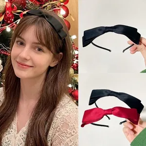Detail view of stylish satin bow headbands in elegant red and classic black colors