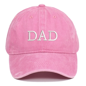 Detailed close-up of pink washed cotton baseball cap with white DAD embroidery texture
