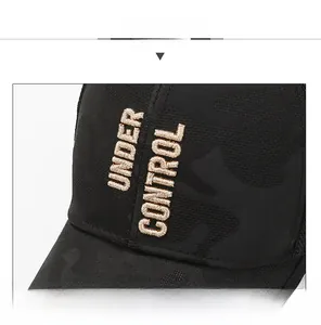 Detail shot of 3D UNDER CONTROL embroidery on black camo mesh baseball cap