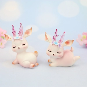 Cute resin deer cake toppers with pastel floral crowns for kids' birthday parties