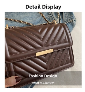Detailed close-up of dark brown crossbody bag with V-shaped chevron quilting and gold chain
