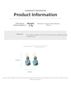 Detail of bohemian geometric wood earrings with blue texture and zircon accents