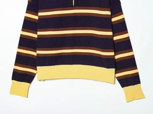 Detail of striped knitted polo shirt with ribbed cuffs and contrast yellow trim texture