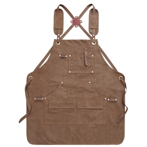 Durable brown canvas work apron with leather trim and multi-pocket cross-back design