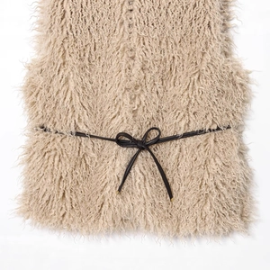 Chic beige faux fur vest with black slim belt for elegant layered winter fashion