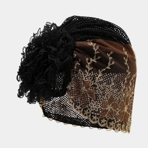 Detail of black lace turban hat for women with red lining and floral embroidery