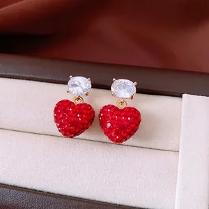 Boucles d'oreilles cœur rouge élégantes avec zircons blancs dans un écrin de luxe