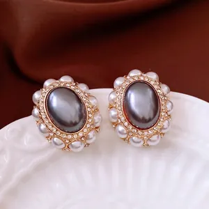Vintage oval pearl earrings with grey center, sparkling crystals and gold metal frame