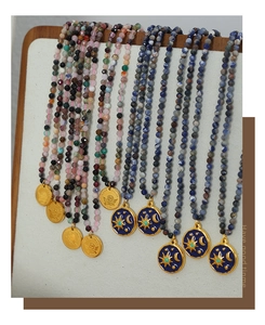 Detail of 316L stainless steel beaded necklaces with angel and celestial enamel pendants