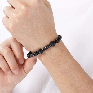Close-up of minimalist black braided steel wire bracelet on a male wrist