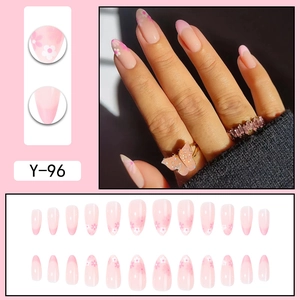 Pink gradient press-on nails with delicate white floral patterns in almond shape