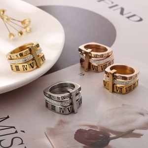 Detailed view of Roman numeral rings with micro-set diamonds in gold and silver finishes