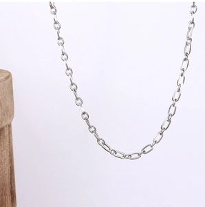 Detail of silver oval link chain necklace in minimalist design with metallic luster