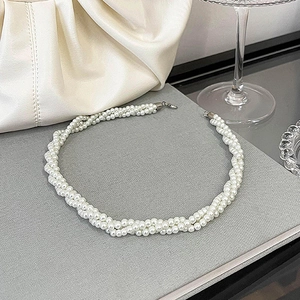 Elegant multi-strand twisted pearl choker necklace with vintage style on grey background