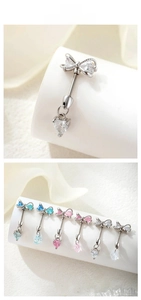 Detail of bow belly rings featuring heart-shaped zircon pendants in six vibrant colors