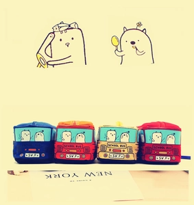 Detail view of four colorful school bus canvas pencil cases with cartoon animal patterns