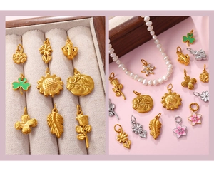 Detailed macro shot of floral daisy charms with enamel and rhinestones on jewelry tray