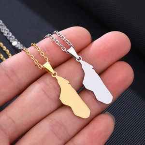 Macro view of gold and silver stainless steel Madagascar map pendants on delicate O-chains