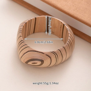 Detail view of square wooden bangle showing natural grain texture and size dimensions