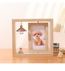 Close-up of rotating wooden photo frame with hanging lampshade and micro landscape