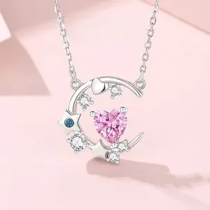 Detail of S925 silver crescent moon necklace with pink heart zircon and blue star charm