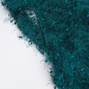 Close-up of dark green textured fabric with long faux fur fiber and high-density weave