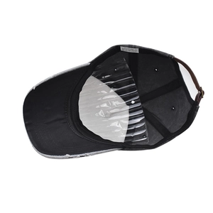 Detail view of washed baseball cap interior with leather strap and metal buckle closure