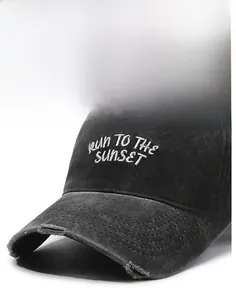 Detail of washed black baseball cap featuring RUN TO THE SUNSET embroidery and distressed brim
