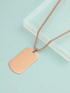 Macro shot of rose gold dog tag pendant on round box chain with metallic luster