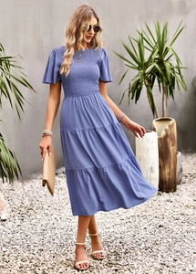 Detail view of waist-slimming blue tiered dress with ruffled sleeves and smocked bodice