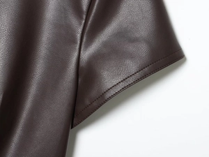 Macro shot of fine double stitching on dark brown PU leather round neck dress detail