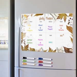 Macro shot of magnetic acrylic weekly planner on fridge with six colorful markers