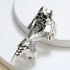 Macro view of articulated punk skeleton armor ring with detailed silver skull and joints